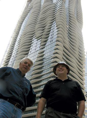 OPP general manager Jim Zmudka (right) with building contractor at the Aqua Tower in Chicago. A major component of construction was OPP's barrier film overlaid panels, specially designed for high alkaline and abrasive concrete applications