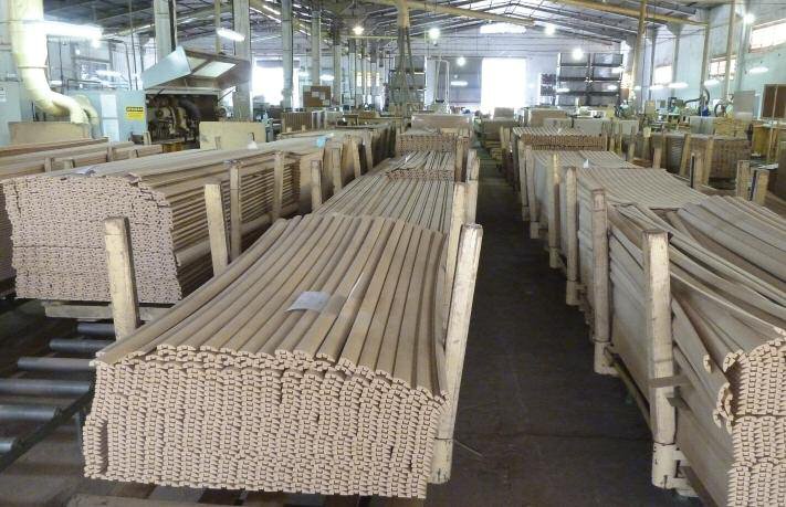Shaped strip mouldings stacked awaiting laminate finishing at the Compomade components plant in Agudos, Brazil