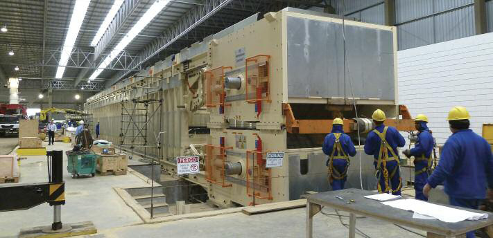 Workers assemble the 40.4m Siempelkamp ContiRoll continuous press for Berneck's 500,000m3/year MDF line at Curitibanos