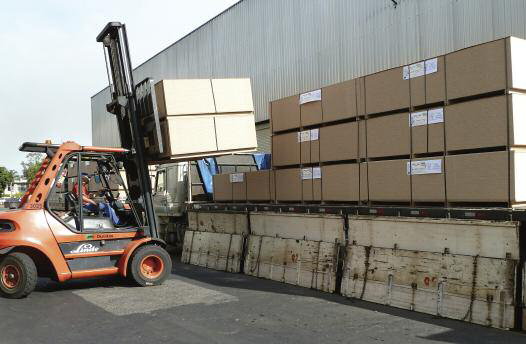 Packs of MDP panels being loaded onto a truck for distribution to Duratex's customers